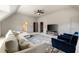 Spacious living room boasts neutral paint, plush sectional, and stylish blue chairs, perfect for relaxing and entertaining at 3720 River Mansion Dr, Peachtree Corners, GA 30096