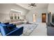 This living room features a large window, plush sectional, and stylish blue chairs, perfect for relaxing and entertaining at 3720 River Mansion Dr, Peachtree Corners, GA 30096