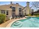 Backyard pool and spa with lounge chairs and manicured landscaping at 3720 River Mansion Dr, Peachtree Corners, GA 30096