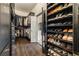 Custom walk-in closet with hanging racks and shoe storage at 3720 River Mansion Dr, Peachtree Corners, GA 30096