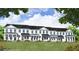 Charming new townhomes with white siding, black trim, and covered front porches offer inviting curb appeal at 54 Black Gum Ln # 48, Auburn, GA 30011