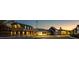 Charming street view showcasing the community's architecture and illuminated buildings at sunset at 54 Black Gum Ln # 48, Auburn, GA 30011