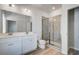 Bathroom features a double sink vanity, a tiled shower with glass door, and wood-look flooring at 608 Marimba Pike, Mcdonough, GA 30253