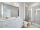 Bathroom features a double sink vanity, a tiled shower with glass door, and wood-look flooring at 608 Marimba Pike, Mcdonough, GA 30253