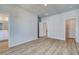 Bright bedroom showcasing wood-look flooring, two doors, and neutral walls, creating a serene space at 608 Marimba Pike, Mcdonough, GA 30253