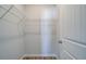 Walk-in closet featuring white wire shelving, neutral walls, and wood-look flooring at 608 Marimba Pike, Mcdonough, GA 30253