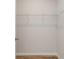 Walk-in closet features white wire shelving, neutral walls, and wood-look flooring at 608 Marimba Pike, Mcdonough, GA 30253
