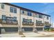 Modern townhome exterior with gray accents, balconies, and attached garages at 608 Marimba Pike, Mcdonough, GA 30253