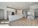Bright kitchen features white cabinets, stainless appliances, and a large island with pendant lighting at 608 Marimba Pike, Mcdonough, GA 30253
