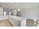 Bright kitchen features white cabinets, stainless appliances, and a large island with storage space at 608 Marimba Pike, Mcdonough, GA 30253