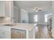Modern kitchen has white cabinets, stainless appliances, and sink is centered on the island at 608 Marimba Pike, Mcdonough, GA 30253