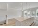 Modern kitchen has white cabinets, a large island with drawers and plenty of natural light at 608 Marimba Pike, Mcdonough, GA 30253