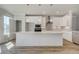 Contemporary kitchen featuring white cabinets, quartz countertops, stainless steel appliances, and an island at 608 Marimba Pike, Mcdonough, GA 30253