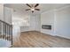 Living area has an electric fireplace, steps nearby and kitchen with white cabinets in the background at 608 Marimba Pike, Mcdonough, GA 30253