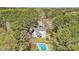 Aerial view of a home featuring a sparkling pool and surrounded by lush, mature trees at 1260 Centenary Rdg, Snellville, GA 30078