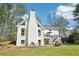 View of white house showing deck, patio, lawn, and stone path at 1260 Centenary Rdg, Snellville, GA 30078