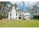 View of the rear of a white house with a deck, patio, lawn and stone path at 1260 Centenary Rdg, Snellville, GA 30078