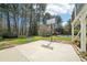 Backyard with basketball hoop, trampoline and distant view of the pool area at 1260 Centenary Rdg, Snellville, GA 30078