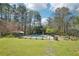 Enjoy the expansive backyard with lush grass, mature trees, and a refreshing pool at 1260 Centenary Rdg, Snellville, GA 30078