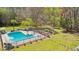 The backyard features a refreshing pool, surrounded by lush landscaping and ample seating areas at 1260 Centenary Rdg, Snellville, GA 30078