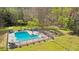 Serene backyard with a sparkling pool, surrounded by mature trees and plenty of space for relaxation at 1260 Centenary Rdg, Snellville, GA 30078
