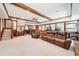 Finished basement featuring a bar, leather furniture, a brick fireplace, and wood trim at 1260 Centenary Rdg, Snellville, GA 30078