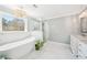 Bright bathroom features modern tub, walk in shower, ceramic tile floors and a double sink vanity at 1260 Centenary Rdg, Snellville, GA 30078