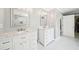 Bright bathroom featuring double vanities with marble countertops and white cabinets, plus marble floors at 1260 Centenary Rdg, Snellville, GA 30078