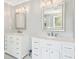 Bright bathroom featuring double vanities with marble countertops and white cabinets at 1260 Centenary Rdg, Snellville, GA 30078