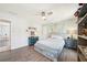 Bright bedroom featuring a wooden bed frame, hardwood floors, a ceiling fan and a bookshelf at 1260 Centenary Rdg, Snellville, GA 30078