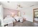 Bright bedroom features two twin beds with white frames, wood flooring and a ceiling fan at 1260 Centenary Rdg, Snellville, GA 30078