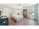 Bright bedroom featuring a wooden bed frame, hardwood floors, a ceiling fan and a bookshelf at 1260 Centenary Rdg, Snellville, GA 30078