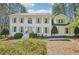 Charming two-story home featuring a white brick facade, complemented by lush greenery and a well-manicured front yard at 1260 Centenary Rdg, Snellville, GA 30078