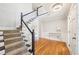 A delightful foyer featuring gleaming wood floors, a winding staircase, and ornate trim in a bright and airy space at 1260 Centenary Rdg, Snellville, GA 30078