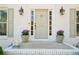 Inviting front entrance featuring a stylish sage-colored door framed by sidelights and potted flowers at 1260 Centenary Rdg, Snellville, GA 30078