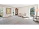 Spacious living room featuring neutral carpet, a grandfather clock, and lots of light from large windows at 1260 Centenary Rdg, Snellville, GA 30078