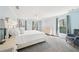 Airy main bedroom features an off white bed set, gray carpet, and plentiful natural light at 1260 Centenary Rdg, Snellville, GA 30078