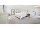 Airy main bedroom features an off white bed set, gray carpet, and plentiful natural light at 1260 Centenary Rdg, Snellville, GA 30078
