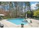 Sparkling swimming pool surrounded by ample seating and serene landscaping offers a relaxing oasis at 1260 Centenary Rdg, Snellville, GA 30078