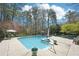 Large in-ground pool is surrounded by comfortable lounge chairs and mature trees, perfect for relaxation at 1260 Centenary Rdg, Snellville, GA 30078