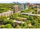 Scenic aerial shot of a building nestled among trees, with a vibrant city skyline in the backdrop at 2260 Peachtree Nw Rd # D6, Atlanta, GA 30309