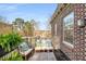 Cozy outdoor seating with pillows on a well maintained, private balcony overlooking mature trees at 2260 Peachtree Nw Rd # D6, Atlanta, GA 30309