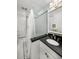 Stylish bathroom featuring a glass shower, black and white tile floor, and updated fixtures at 2260 Peachtree Nw Rd # D6, Atlanta, GA 30309