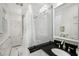 Stylish bathroom featuring a glass shower, black and white tile floor, and updated fixtures at 2260 Peachtree Nw Rd # D6, Atlanta, GA 30309