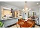 Cozy dining room featuring a chandelier and access to the kitchen and living room at 2260 Peachtree Nw Rd # D6, Atlanta, GA 30309