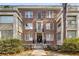 Charming brick building with symmetrical design, balcony, and well-maintained landscaping enhancing curb appeal at 2260 Peachtree Nw Rd # D6, Atlanta, GA 30309