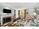 Comfortable living room with a fireplace, built-in shelves, and a door leading to the outside at 2260 Peachtree Nw Rd # D6, Atlanta, GA 30309