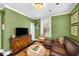 Charming living room with green walls, built-ins, and a leather sectional sofa at 2260 Peachtree Nw Rd # D6, Atlanta, GA 30309