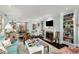 Bright living room featuring a fireplace, built-in bookshelves, and seamless access to the dining area at 2260 Peachtree Nw Rd # D6, Atlanta, GA 30309