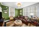 Charming living room with green walls, built-ins, and a leather sectional sofa at 2260 Peachtree Nw Rd # D6, Atlanta, GA 30309